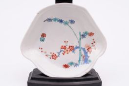 A Chantilly fan-shaped saucer painted in the Kakiemon palette with bamboo and flowering