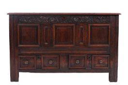 An early 18th Century French provincial oak mule chest the hinged top above a frieze carved with
