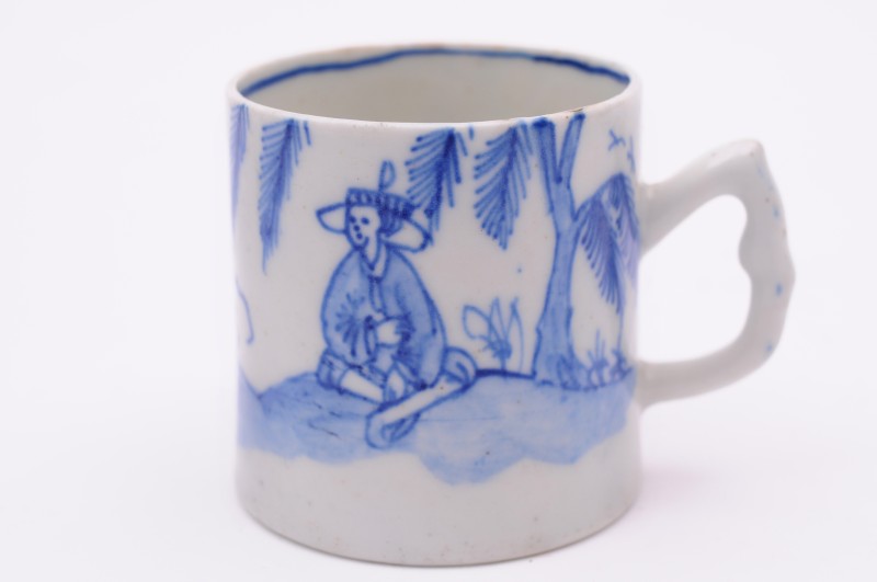 A Bow blue and white coffee can with angular moulded handle, painted with the ‘Cross Legged