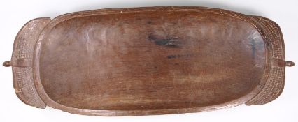 A West African hardwood fruit bowl of rectangular outline, the handles and base in the form of