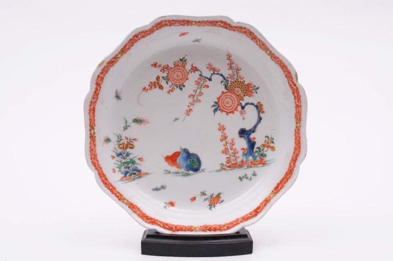 A Bow shaped shallow bowl decorated in the Kakiemon palette with two quails, a flowering prunus
