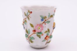 A Chelsea teaplant beaker of lobed form moulded with teaplant flowers and foliage and painted in