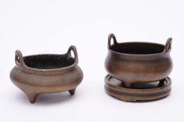 A Chinese polished bronze tripod censer with loop  handles, bears six character Xuande mark, 10.5cm.