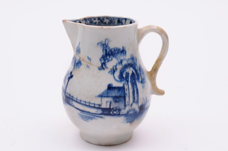 A Lowestoft sparrow beak cream jug painted in blue with oriental buildings and bridges in water