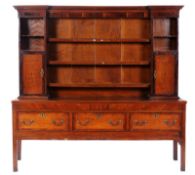 An early 19th Century oak, mahogany, crossbanded and inlaid dresser, bordered with ebonised and