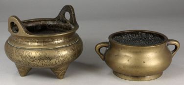 A Chinese polished bronze tripod censer with loop handles and engraved with a phoenix, bats and