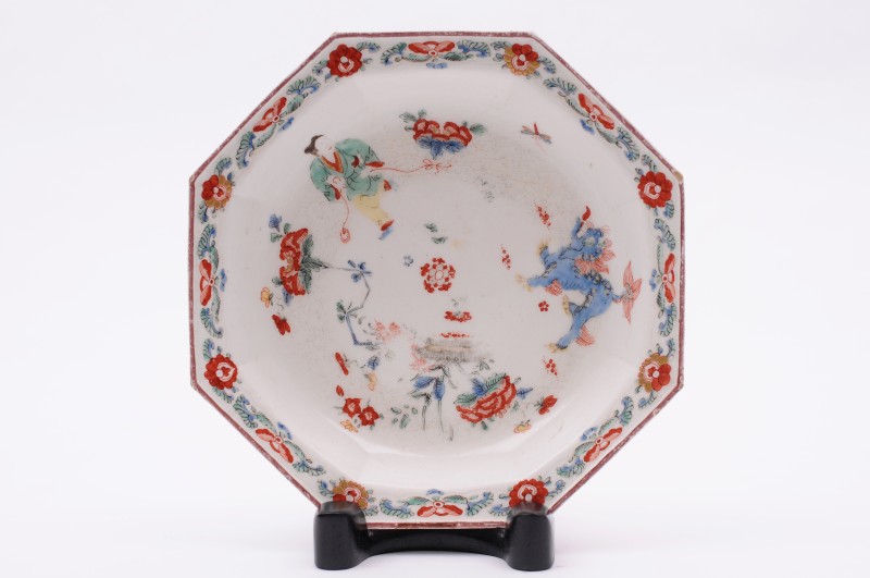A Bow octagonal deep dish painted in the Kakiemon manner with a dancing boy holding a long ribbon, a