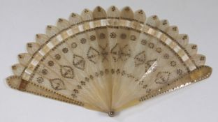 An early 19th century horn fan, the pierced fret cut foliate decorated sticks further decorated with