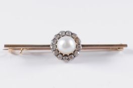 A pearl and diamond mounted bar brooch the central, bouton pearl 7.5mm diameter, within a surround
