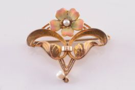 An early 20th century enamelled gold and seed-pearl pendant brooch of openwork foliate design with