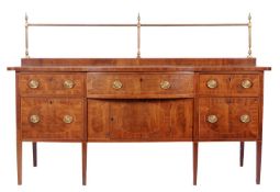 A late George III mahogany serpentine fronted sideboard, outlined with boxwood stringing, the