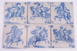 Six Dutch Delft tiles each painted in blue with a cavalry soldier on a galloping horse, four