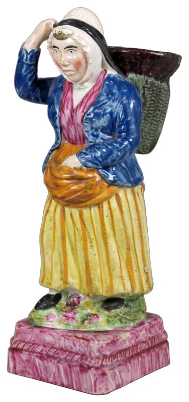 A Portabello pearl glazed pottery figure of a fish wife probably Thomas Rathbone & Co., carrying a