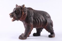 A Swiss carved linden wood Black Forest bear  walking on all fours, with painted open mouth, and