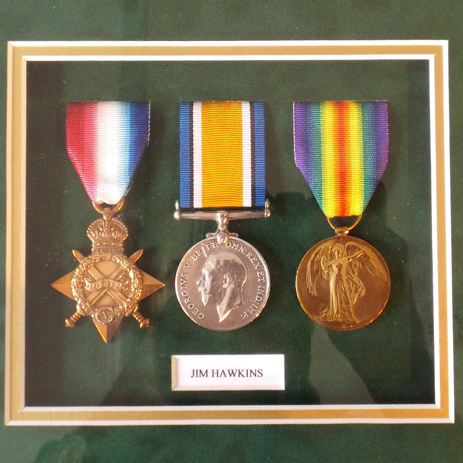 FRAMED TRIO OF WORLD WAR I MEDALS PRESENTED TO J HAWKINS OF THE ARMY SERVICE CORE.