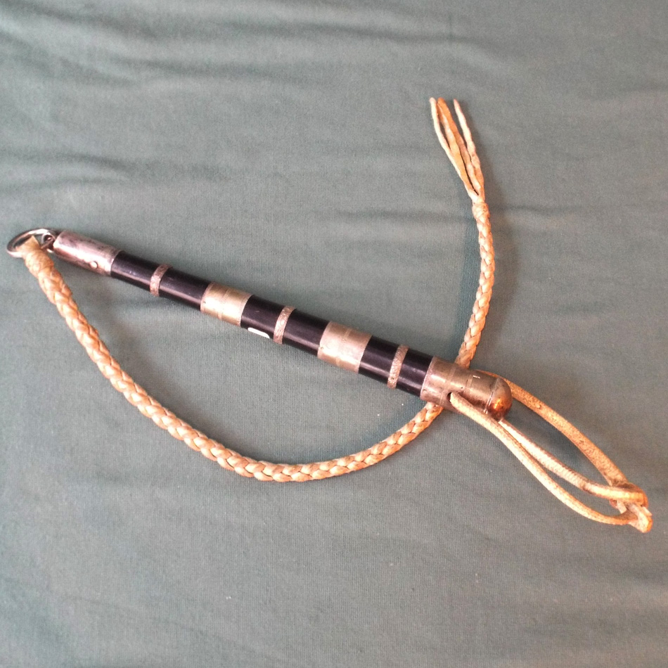 MIDDLE EASTERN CAMEL WHIP WITH EBONY AND WHITE COLOURED METAL HANDLE.