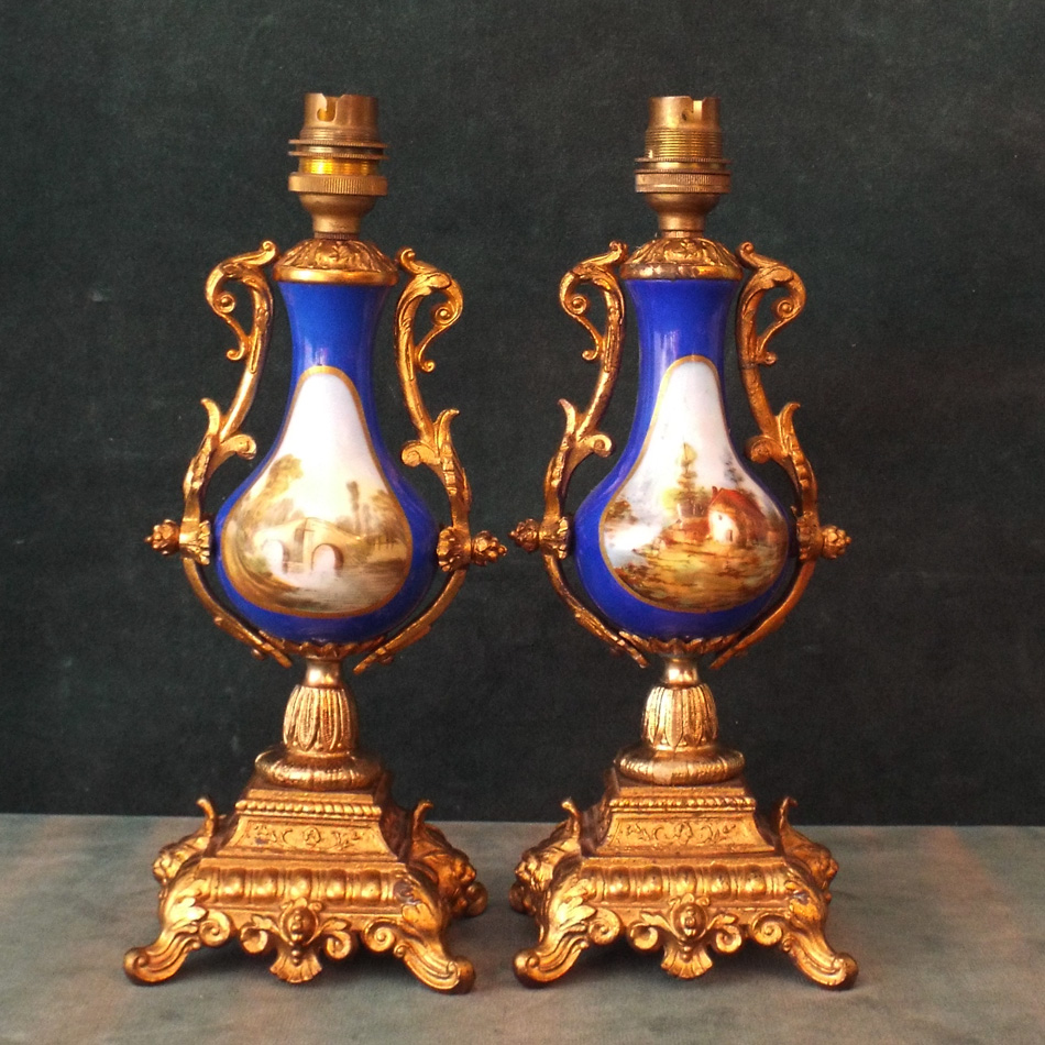PAIR OF GILT METAL AND PICTURE PANEL PORCELAIN TABLE LAMPS.