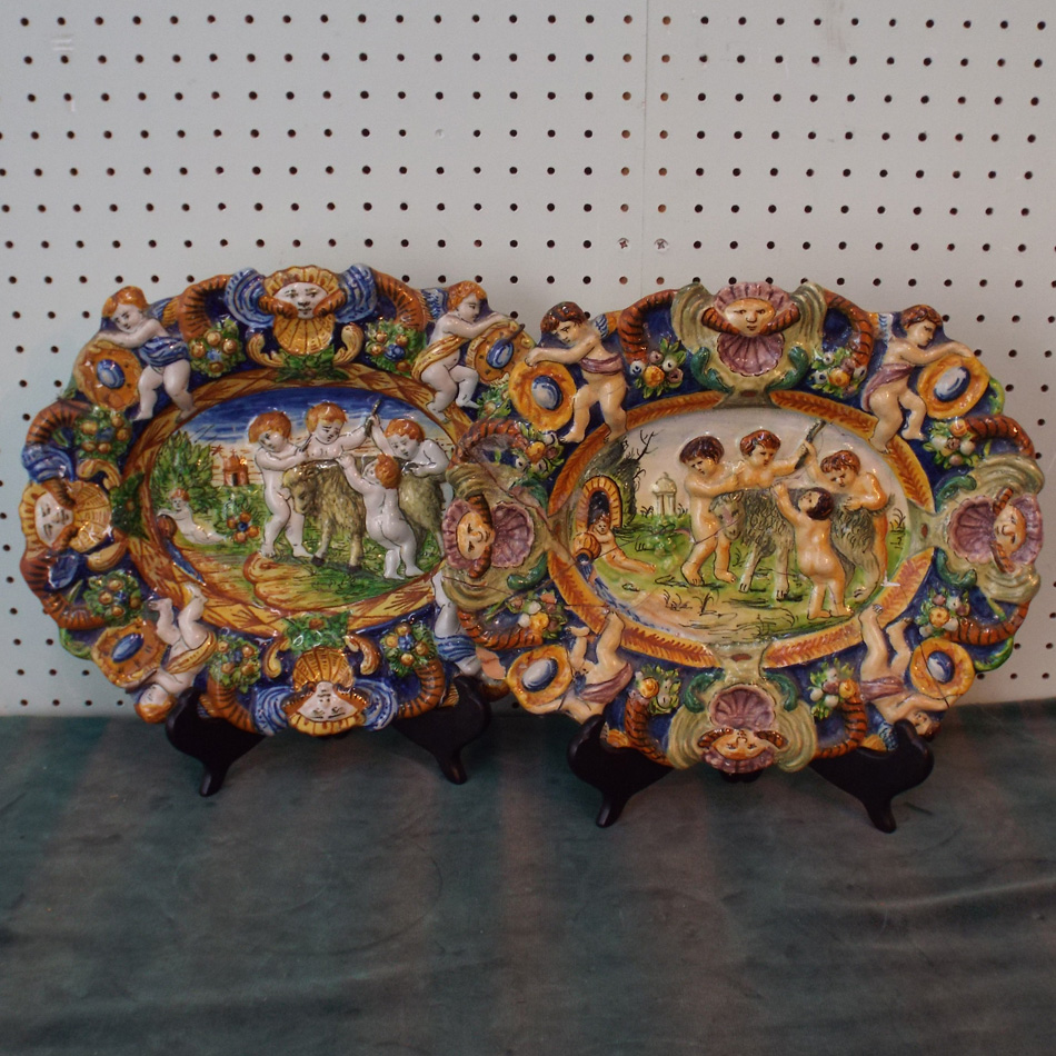 PAIR OF ITALIAN MAJOLICA SHALLOW DISHES OF OVAL FORM WITH RAISED CLASSICAL CHERUB DECORATION. 30cm