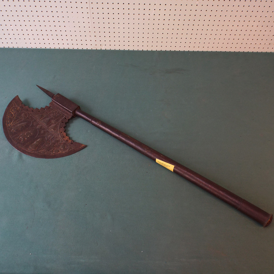 OLD MIDDLE EASTERN WAR AXE WITH EMBOSSED AND PIERCED DECORATION AND WOODEN HANDLE.