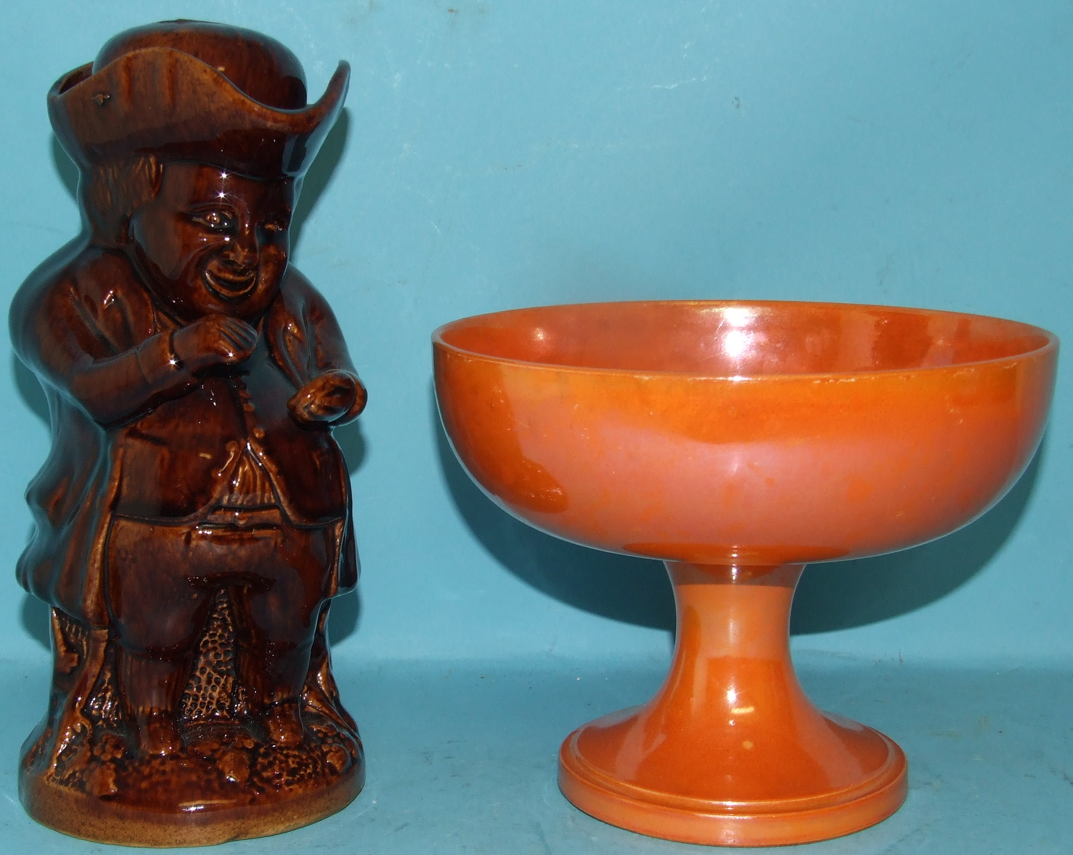 A Moorcroft orange glazed pedestal bowl, 19.5 cm diameter, and a brown treacle glazed Toby jug (2)