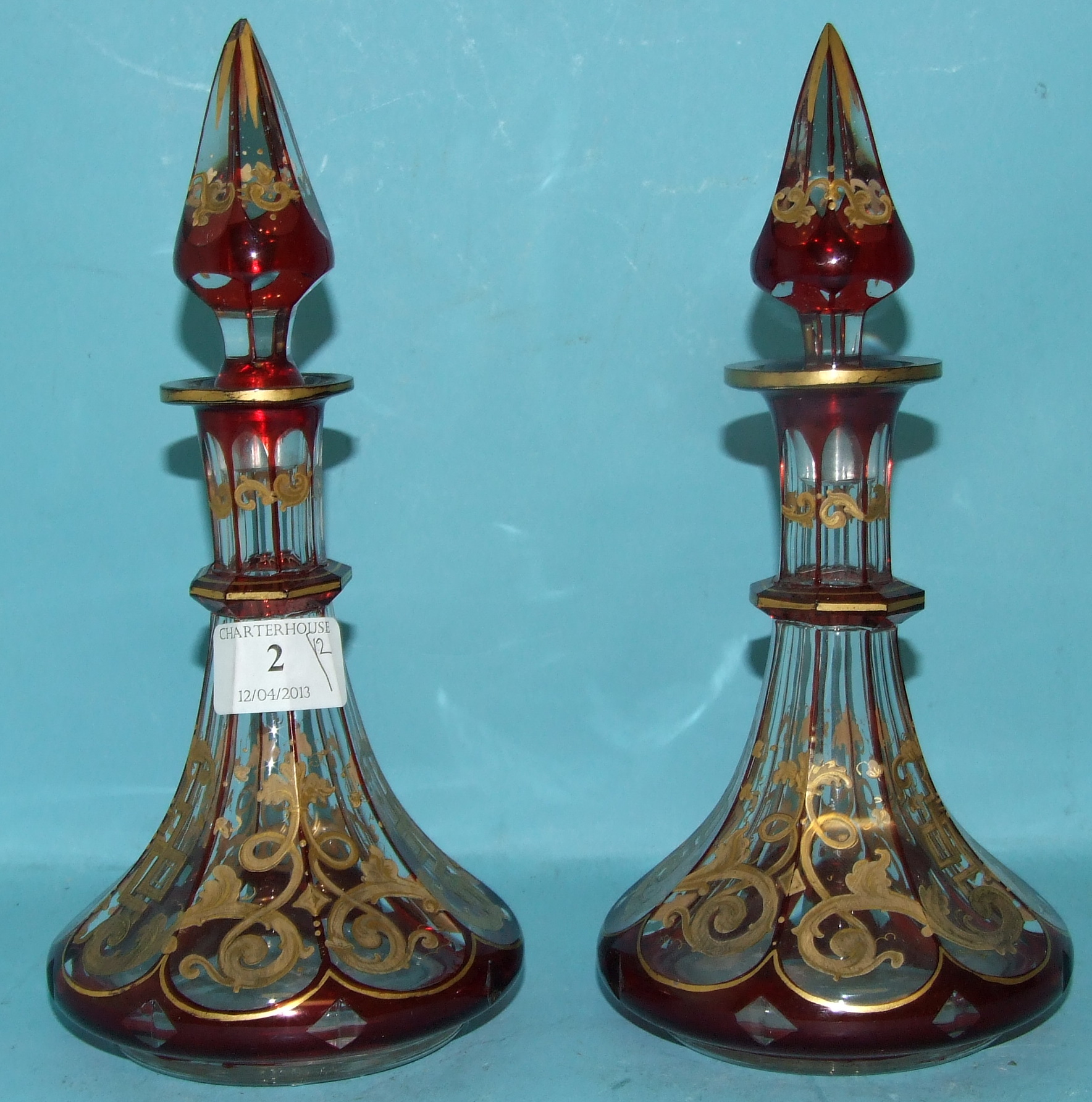 A pair of Bohemian glass scent bottles and stoppers, with red flashed and gilt decoration (one