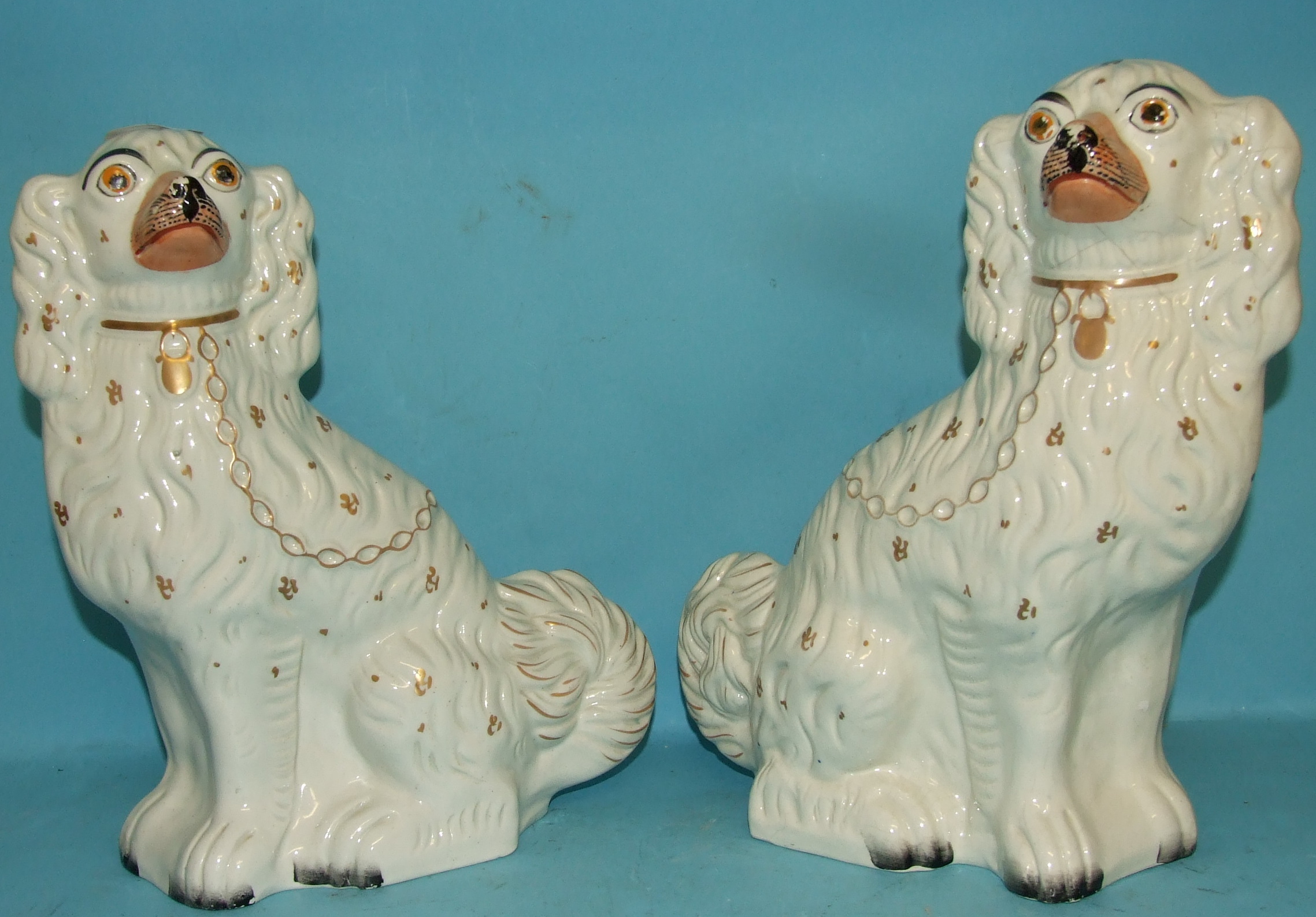 A pair of Staffordshire pottery dogs, 30 cm high (a.f.) (2)