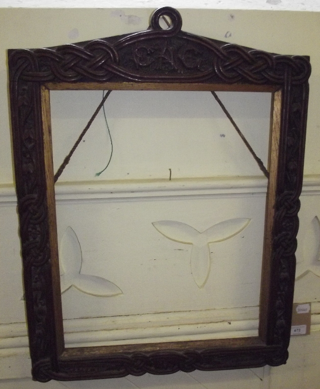 A 19th century carved oak frame, decorated Celtic type knots and  stylised flowers, initialled,