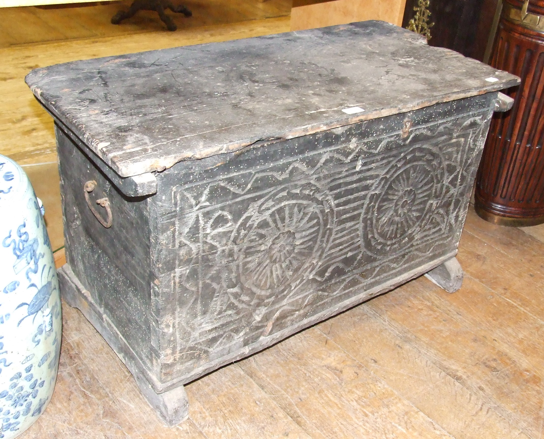 A stained pine coffer, with a carved front panel, on sledge feet, 95 cm wide