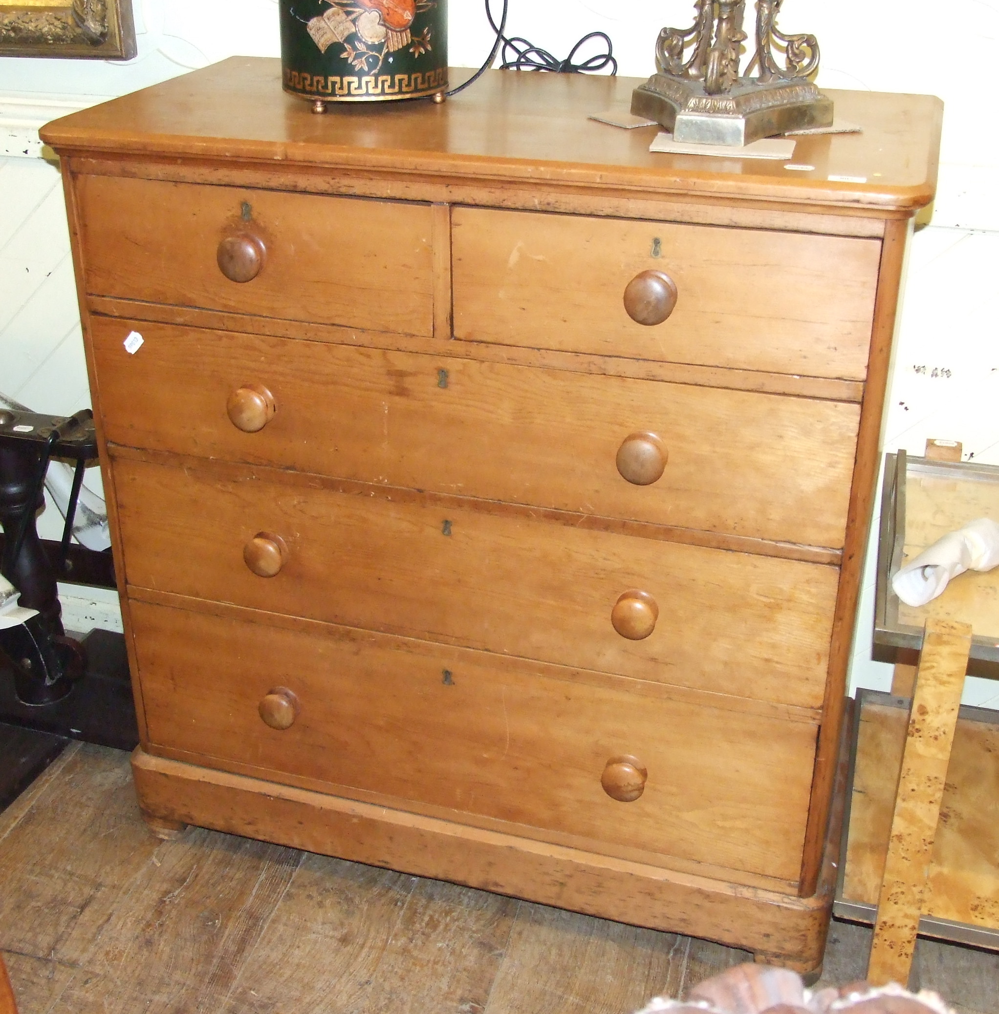 A stripped pine chest of five drawers, 107 cm wide