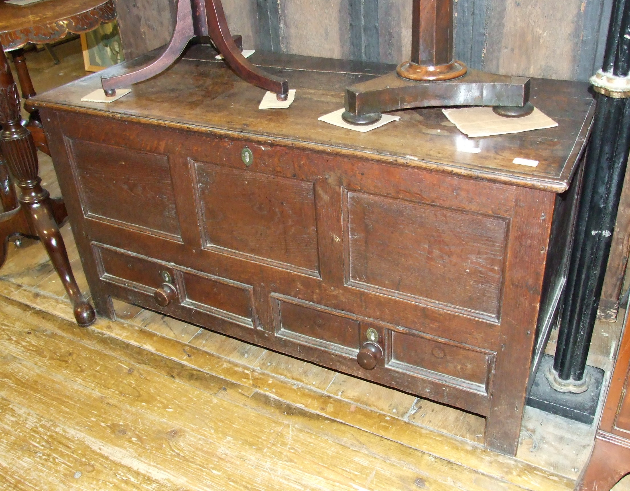 An 18th century oak mule chest, on stile legs, 120 cm wide