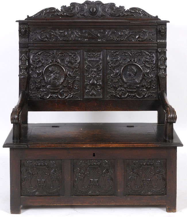 A late 19th century French oak box settle, carved face masks and scrolling acanthus leaves, 116 cm