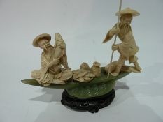 Oriental simulated ivory and simulated jade figure group of two fisherman on punt with carved