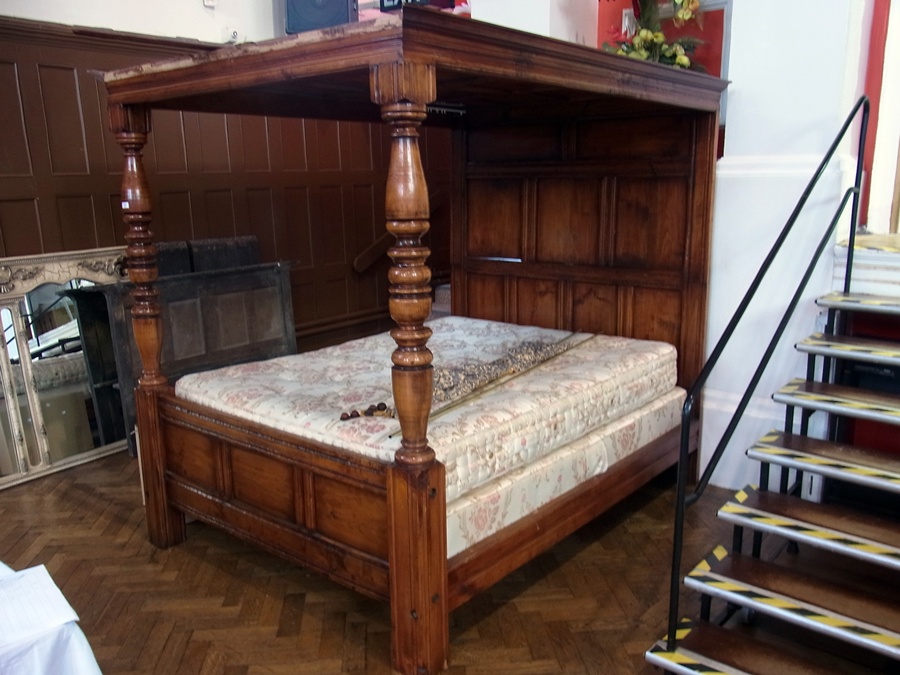 Reproduction hardwood four poster bed, panelled top, back and front board with turned supports,