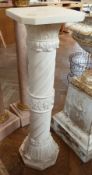 Modern alabaster effect plinth, with square top, carved pillar base with central leaf border on