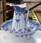 A Victorian pottery ewer and basin, blue and white Burslem pattern with scroll and swag decoration