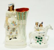 A Staffordshire flatback figure group "Returning Home", and a Staffordshire flatback spill vase,