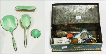 Silver-plated and green enamelled three-piece dressing table set,  a similar powder compact, badges,