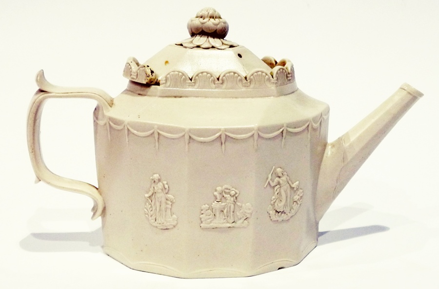Castleford-type stoneware teapot, the sliding panel lid with foliate finial, raised arch edge to the