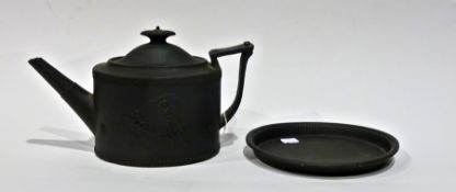 Early nineteenth-century black basalt teapot on stand, oval with angular handle with shell and