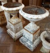 Pair white painted cast iron jardinieres circular with shaped tops on plinth bases, decorated with