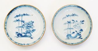 Two Chinese Nanking Cargo blue and white tea bowls with saucers, decorated with painted underglaze