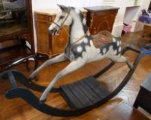 Victorian dapple painted rocking horse, circa 1850, with leather studded saddle, on black painted