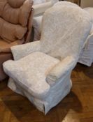 A reproduction Victorian style armchair, in floral covered upholstery