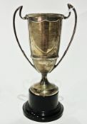 WITHDRAWN

Silver trophy cup, cylindrical, slightly tapered with upswept scroll handles,