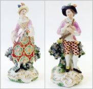 Pair eighteenth-century Chelsea Derby figures, boy with pipe and girl with flowers, each wearing