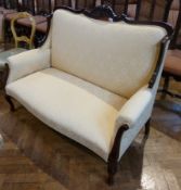 Edwardian Mahogany and cream damask two seater settee with square back, having foliate carved