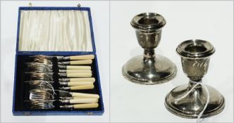 Pair silver candleholders, each with circular sconce on circular foot, and set of six cream