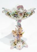 Plaue porcelain centrepiece with ornate floral encrusted boat shape basket on cherub decorated