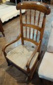 Antique hardwood yew and elm rush seated Lancashire back open arm rocking chair with two rows turned