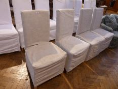 Set of four modern cream covered dining chairs with padded back and seat, on tapering straight